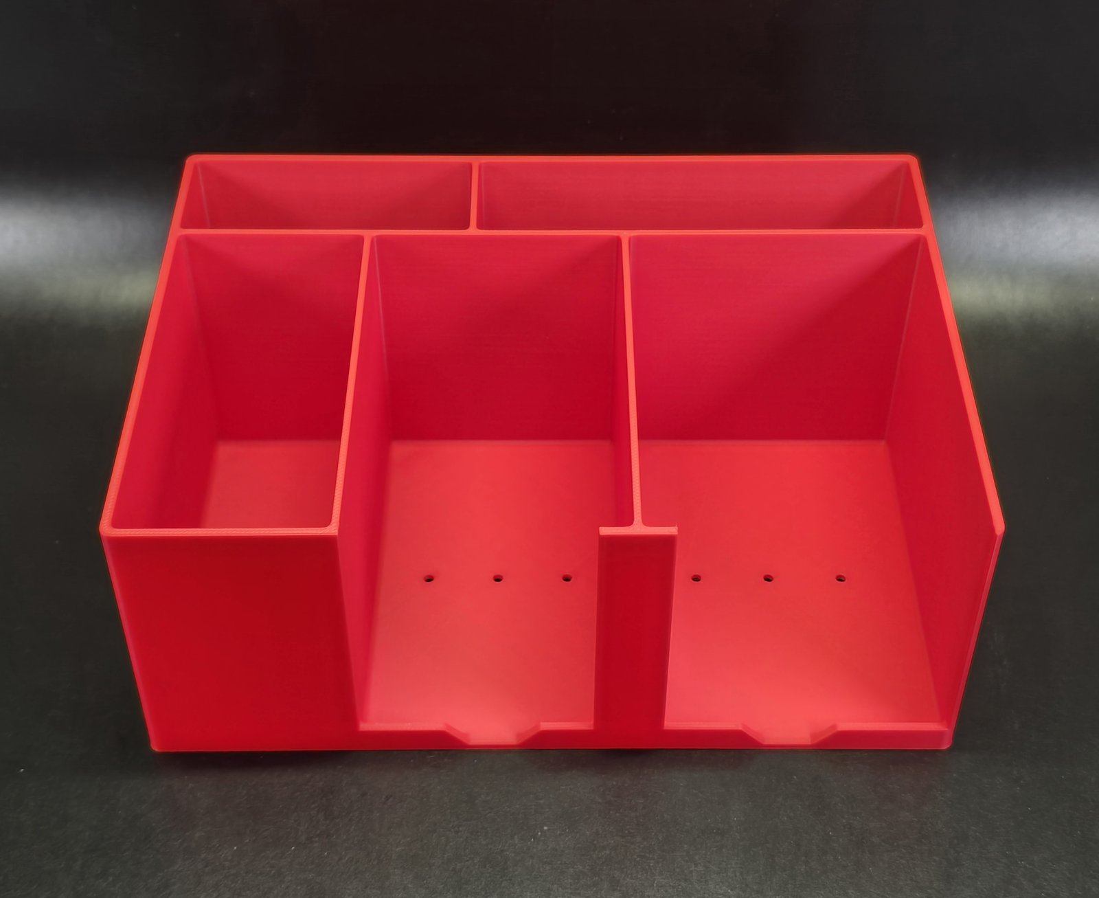 A red Card Packing Station Organizer, shown empty from above and in front