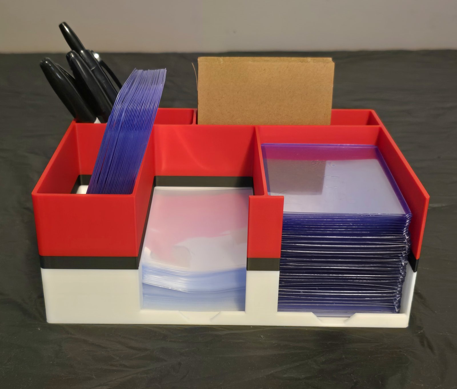 The Poké Ball station loaded with toploaders, sharpies, and shipping cardboard